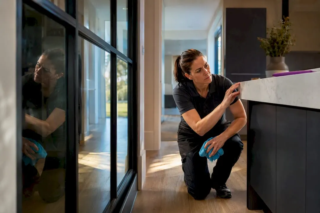 Cleaner inspecting newly completed interior